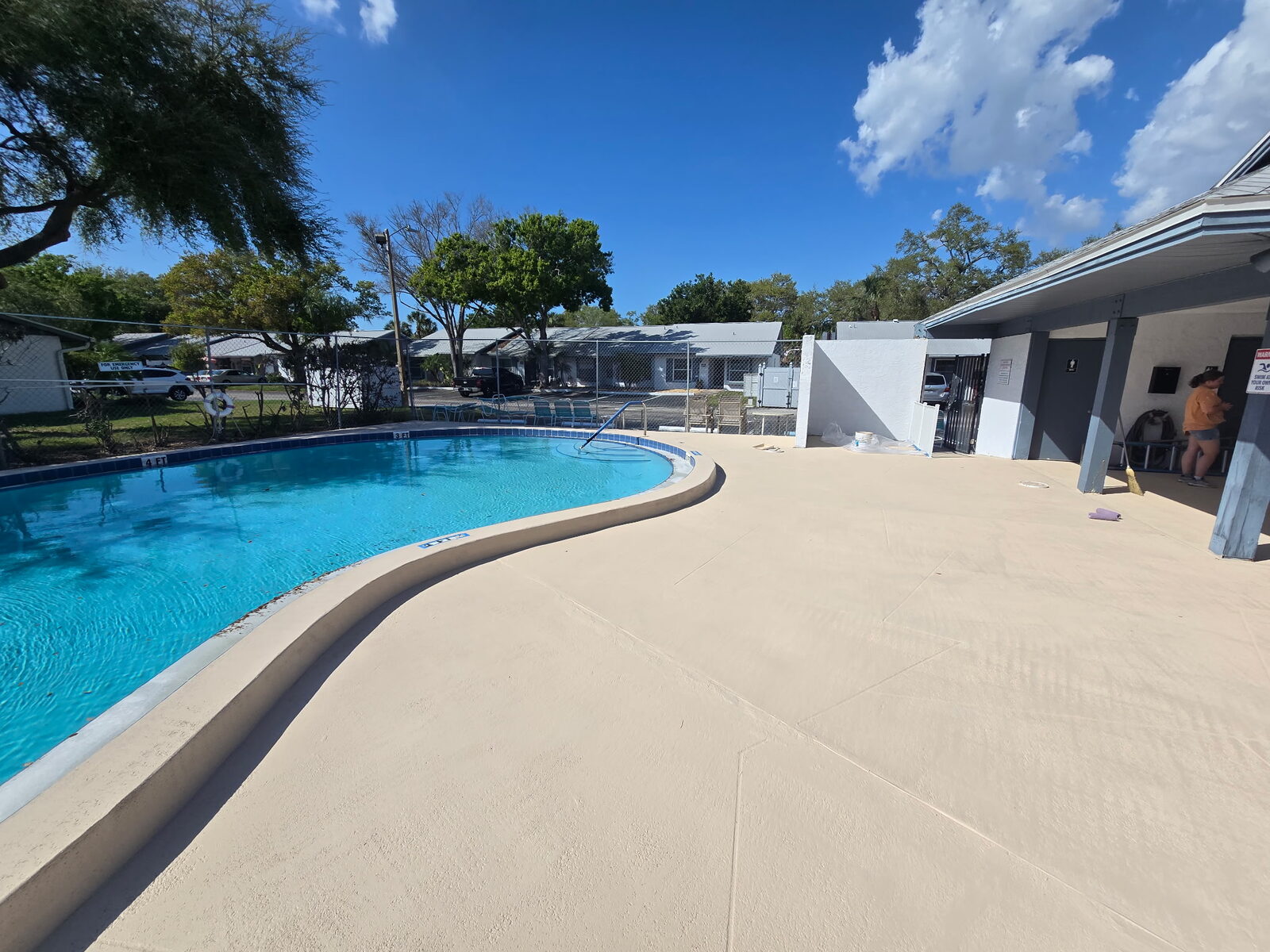 Refinished pool deck with smooth, sealed concrete coating